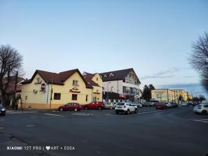 a city street with cars parked on the street at Pensiunea Buon Gusto Sibiu-motorcyle friendly,city center in Sibiu