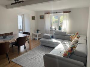 a living room with a couch and a table at Quiddelbacher Mühle in Quiddelbach