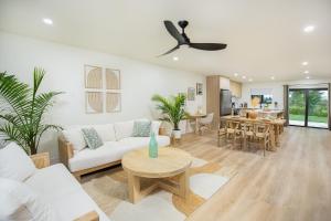 a living room with a white couch and a table at Boho Bliss - Reset & Recharge Wellness House in Naples