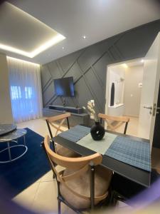 a dining room with a black table and chairs at guesthouse apartments in Tirana