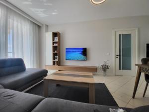 a living room with a couch and a table at Alex's Apartment 2 in Durrës