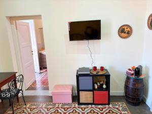 a living room with a tv on a wall at Medinat House in Catania