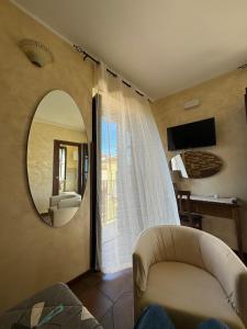 a living room with a mirror and a couch at B&B Rivellini in Tropea