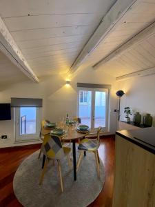 a dining room with a table and some chairs at VicomilleSuites Cagliari Adult Only in Cagliari