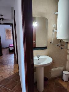 a bathroom with a sink and a mirror at Appartement Cassia situé à Cabo Negro in Tétouan