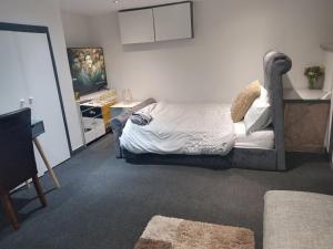 a bedroom with a bed and a tv in it at Affordable Private Space in a Central Part of Leeds- Free WIFI, Free Parking in Leeds