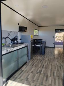 a kitchen with a counter top and a dining room at El Paraíso Escondido in San Juan