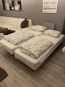 a group of four mattresses sitting in a room at Trivelig leilighet i Kristiansand sentrum! in Kristiansand