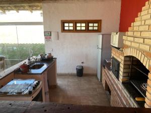 a kitchen with a sink and a stove top oven at Rancho Saramago in Jundiaí