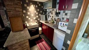 a small kitchen with a sink and a stove at Jahorina Villa Krila in Jahorina