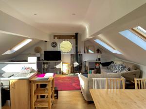 a living room with a couch and a table at The Hayloft, Marsden in Huddersfield
