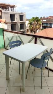 a white table and two chairs on a balcony at Residencial Ilha do Fogo app 205 in Santa Maria