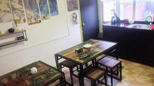 a kitchen with a table and two chairs and a sink at Hostal Host Patagonia in Punta Arenas