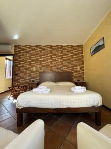 a bedroom with a bed with two towels on it at B&B Rivellini in Tropea