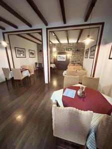 a dining room with a table and white chairs at Restaurant & Apartments JUG in Sutomore