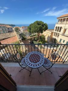 a balcony with a table and a view of the ocean at B&B Rivellini in Tropea