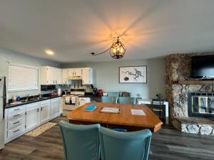 a kitchen with a wooden table and a kitchen with a fireplace at Lakefront condo with a VIEW Osage Beach in Osage Beach