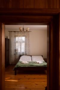 a small bedroom with a bed with a window at Agroturystyka Łączka in Harasiuki