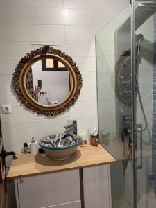 a bathroom with a sink and a mirror and a bowl at Sierra de Huelva-Chalet completo in El Cerro de Andévalo +11 photos