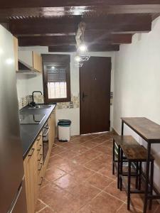 a kitchen with a sink and a table and a counter at Sierra de Huelva-Chalet completo in El Cerro de Andévalo