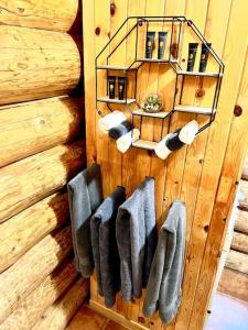 a row of mittens hanging on a wooden wall at Chalets Terre de L'Orme Chalet Bois Rond 2 in Saint-Gabriel-De-Valcartier