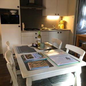 a kitchen with a table with a bottle of wine at Chalet Relax in Zutendaal