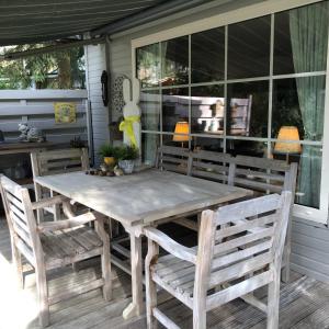 a wooden table and chairs on a porch at Chalet Relax in Zutendaal