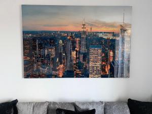 a painting of a city skyline on a wall at Luxury Apartment with Balcony in Dewsbury