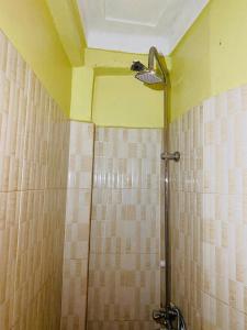 bagno con doccia e soffitto giallo di A Fineshade Apartment a Jinja Altre 6 foto