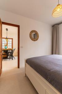a bedroom with a bed and a dining room at Casa Narnia in Puerto del Carmen +12 photos