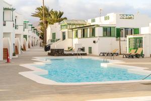 a swimming pool in front of a building at Casa Narnia in Puerto del Carmen