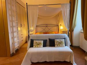 a bedroom with a white bed with two pillows at Casa Vacanze Palazzo Primoli in Ariccia