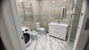 a bathroom with a toilet and a sink and a mirror at Apartament in Bălţi