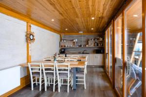 a kitchen and dining room with a table and chairs at Panoramic Residence in Borşa