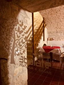 a room with a table and a tree mural on the wall at Tre Balate Natura e Relax in Modica