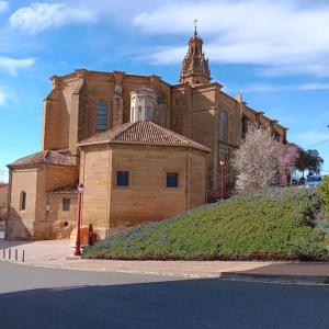 a large brick building with a tower on top of it at Piso en plena Herradura. in Haro