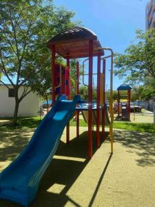 a playground with a slide in a park at Apartamento de descanso in Ricaurte