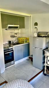 a kitchen with a stove and a refrigerator at Esturion de Montoya - La Barra - Punta del Este - 4 pasajeros in Punta del Este