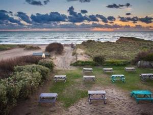 a group of picnic tables on the beach at Beach House B&B in Bude