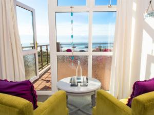 a living room with a view of the ocean at Beach House in Bude