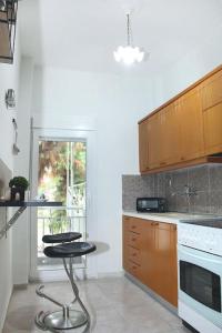 a kitchen with two stools in front of a counter at Blue swing chair apartment in Perea