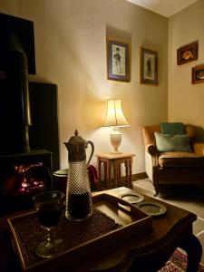 a living room with a coffee table and a fireplace at NEW -Historic cottage with oak beams & period charm in Llangadog