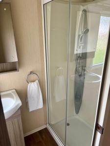 a bathroom with a shower and a sink at The best views on site. Haven Reighton Sands Filey in Reighton
