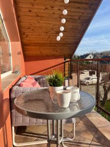 a table on a balcony with a couch at Podkrovní apartmán s balkónem in Ostrava