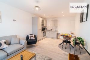 a living room with a couch and a table at Spacious Apartment close to High Street, with Free Parking RockmanStays - Apartment 3 in Brentwood