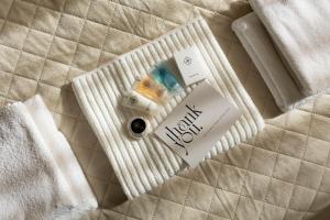 a pack of pills sitting on a bed at Grand Central Suites in Zandvoort