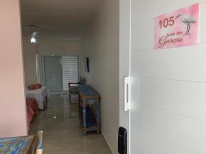 a hallway of a room with a room with a bed at São Francisco Flats in Guapé