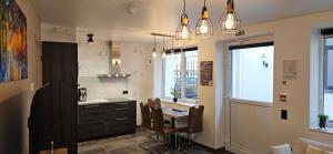 a kitchen with a table and chairs and a desk at Peace Haven in Ypres