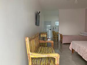 a room with chairs and a bed and a table at São Francisco Flats in Guapé