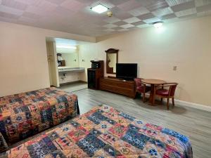 a hotel room with two beds and a table at Knights Inn Galax in Galax